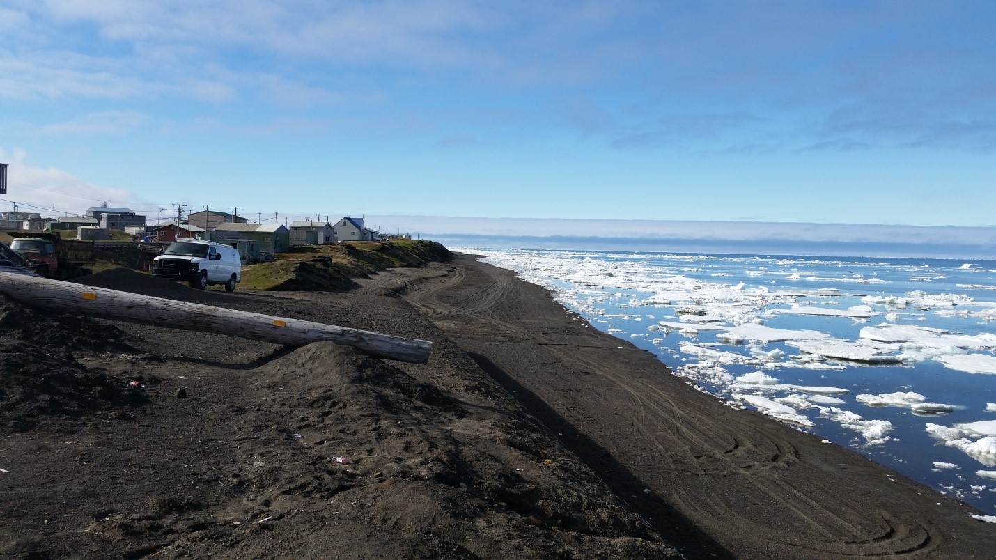 Eroding ancient North Slope dwelling mounds below threatened homes. (Photo courtesy of M. Brady)