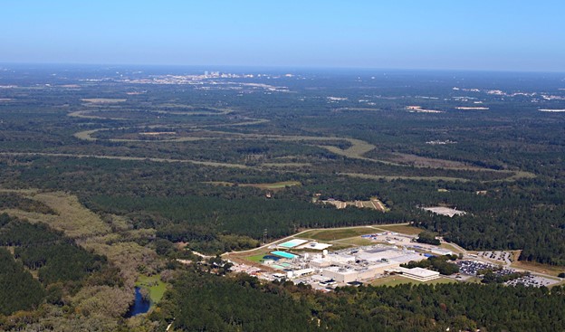 An aerial photograph of a nuclear fuel fabrication facility surrounded by forested land