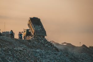 Garbage truck dumping trash into landfill