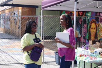 Ezrach Executive Director Dr. Edidiong (Didi) Mendie (left) discusses the project with Mrs. Dara Caldwell-Ross, a local resident and daughter of Elder Ben Caldwell, known as the Father of Leimert Park.